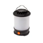 Тонкий светящийся фонарь Fenix CL30R LED для активного отдыха походов путешествий и альпинизма на фоне туристического снаряжения и обуви для активной жизни